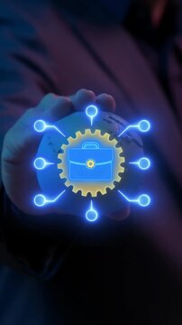 Businessman hand holding world globe vertical shot with glowing business model briefcase and gear icons. Global commercial strategy framework, corporate enterprise value, and planning concept.