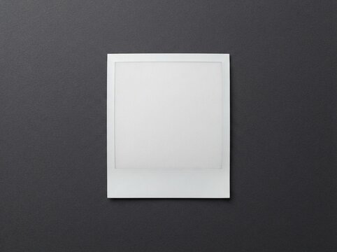 Blank Polaroid Photo Frame Displayed Against Neutral Backdrop