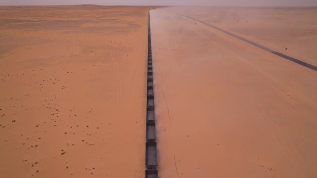 Long Iron Ore Train Through the Mauritanian Sahara Desert