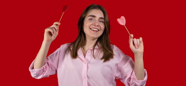 Happy,cheerful in love woman against studio background. St Valentine's copy space banner