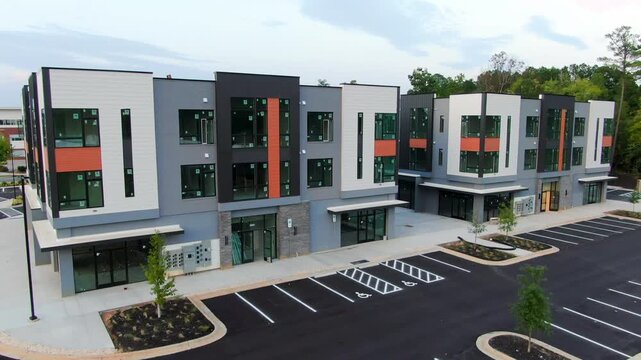Aerial Rising View of Modern Commercial Storefronts and Office Park Facade