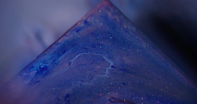 Shimmer mix. Color ink. Defocused blue color triangle sparkling oil water gleam texture floating on abstract acrylic art background.