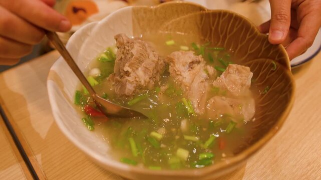 Serving Leng Saap Spicy Pork Bone Soup in Bangkok Restaurant
