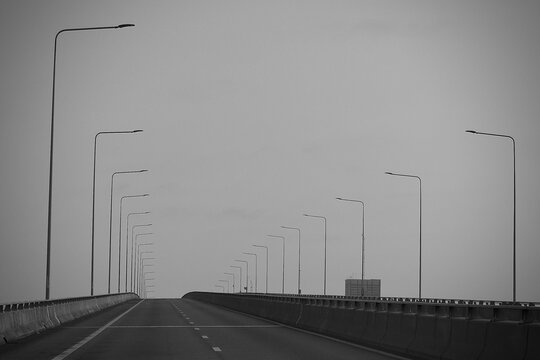 Minimalist Elevated Highway with Repeating Street Lights Disappearing Into the Distance