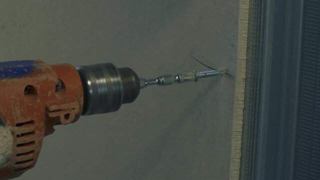 Extreme macro of a screw sunk into a gypsum board panel