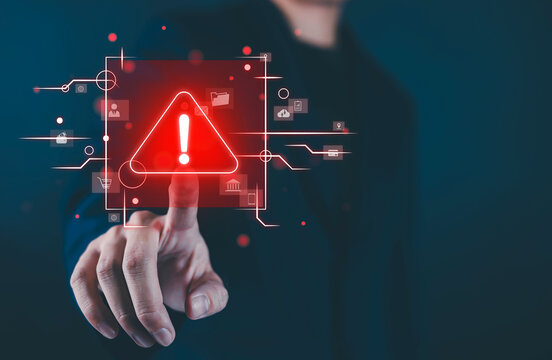 Cybersecurity warning concept with a hand touching a red alert icon, digital interface, network protection, data security, privacy, threat detection, online risks, and technology systems for business.