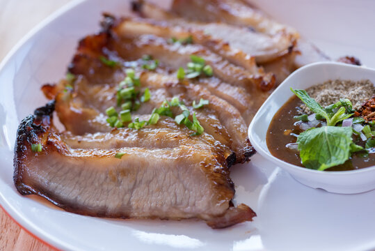 Authentic Thai Grilled Pork Neck Served with Spicy Jaew Dipping Sauce