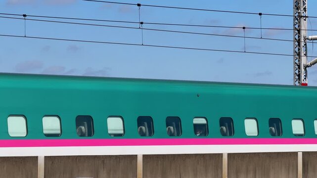 Coupled Hayabusa and Tsubasa Shinkansen Trains Passing Side by Side in Tokyo
