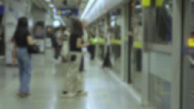 blurred out of focus view inside subway train platform station with passenger get into train and crowded of passenger out from train commuter. subway underground transportation in rush hour