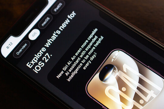 Quetzaltenango, GUATEMALA - Sep 15 2026 : Smartphone is displaying Apple's iOS 27 page with the headline about exploring new features and a section introducing Siri AI as a more capable assistant.