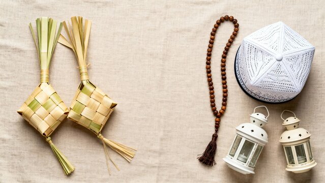 Symmetrical Eid Celebration Still Life with White Kufi and Palm Leaf Ketupat