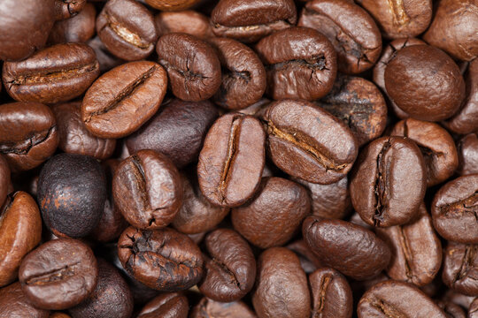 Macro shot of roasted coffee beans background texture.