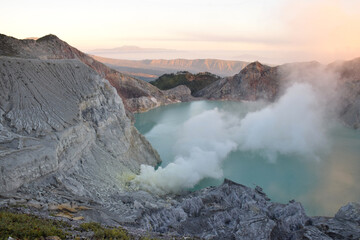 The beauty of Mount Ijen, with smoke rising from the crater against the backdrop of a green lake. © DODO HAWE