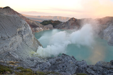 The beauty of Mount Ijen, with smoke rising from the crater against the backdrop of a green lake. © DODO HAWE