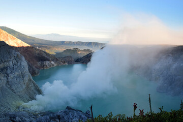 The beauty of Mount Ijen, with smoke rising from the crater against the backdrop of a green lake. © DODO HAWE