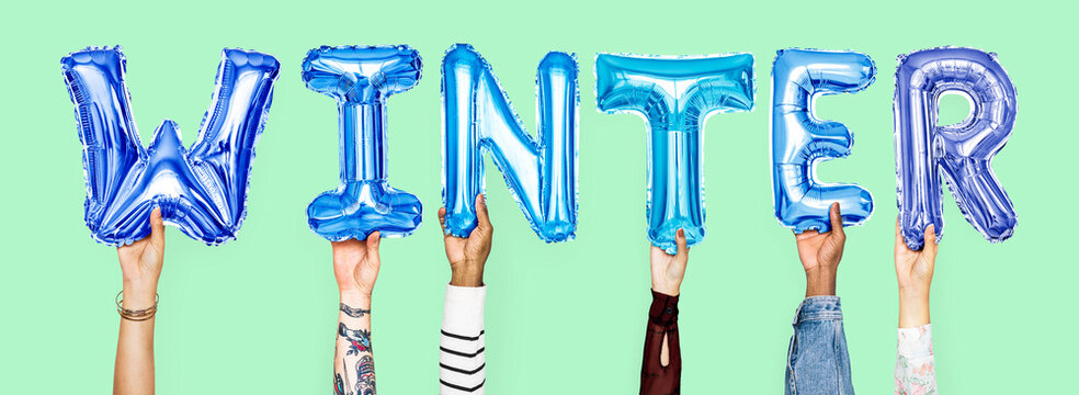 Hands holding balloons spelling Winter