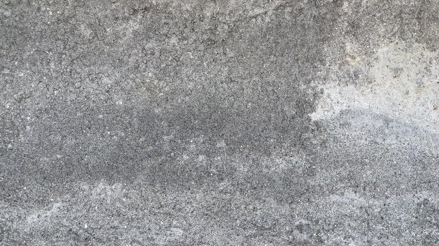 Texture concrete wall of light grey color cement texture background.Grey pastel rough crack cement texture stone concrete,rock plastered stucco wall; painted flat fade background. Side view. close up.