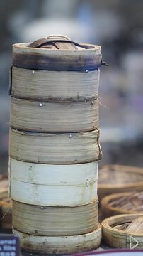 Steamed bamboo containers stacked in a food market setting
