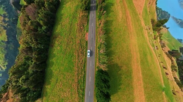Aerial shot of New Zealand, a car driving on a mountainside road, Akaroa