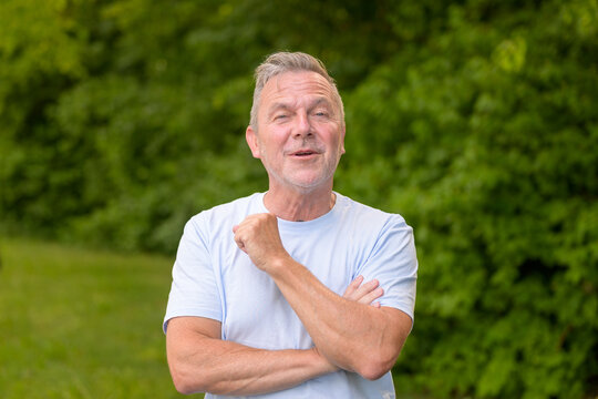Confident Senior Smiling With Folded Arms