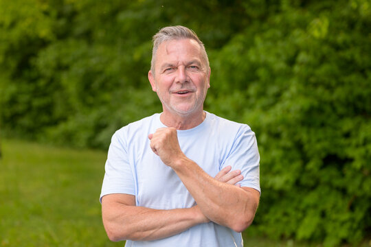 Confident Senior Standing Arms Crossed Smiling