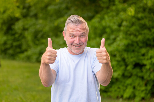 Happy Senior Showing Double Thumbs