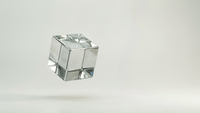 Clear glass cube with internal reflections floating on white keywords: glass, cube, clear