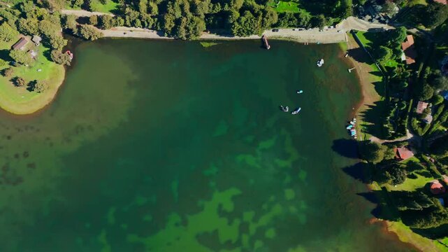 Aerial drone view of top-down view of a winding reservoir inlet lined with small houses and farmland in the State of Mexico, central Mexico