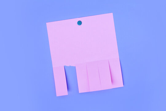 Pink tear off flyer with multiple detachable tabs and one strip torn away on purple background. Blank notice template for advertisements or contact tear off notes