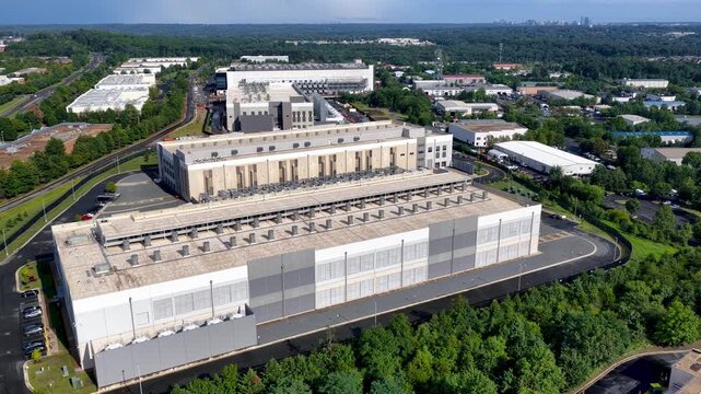 Aerial orbiting shot of a modern data center building in Ashburn, Virginia.