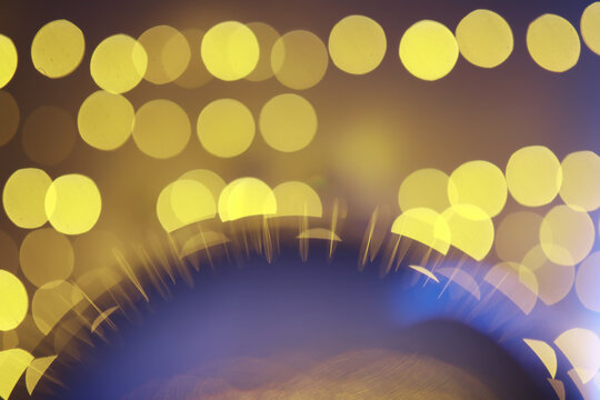 Abstract bokeh background. Golden bokeh circles on dark blue background. Layer overlay.