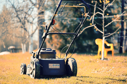 Lawnmower on a yellw meadow in autumn