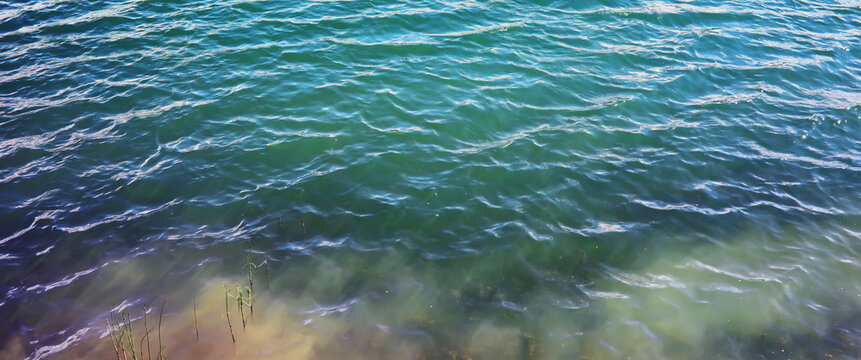 Water surface. The texture of the water. Waves on the lake in windy weather.