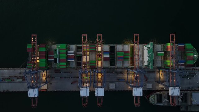 Aerial view container cargo ship loading unloading at night, Container cargo ship import export sea port, Global trade business container cargo ship freight shipping commercial trade logistic