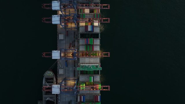 Aerial view container cargo ship loading unloading at night, Container cargo ship import export sea port, Global trade business container cargo ship freight shipping commercial trade logistic