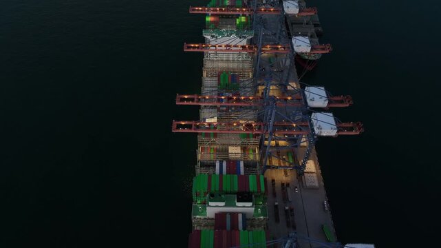 Aerial view container cargo ship loading unloading at night, Container cargo ship import export sea port, Global trade business container cargo ship freight shipping commercial trade logistic