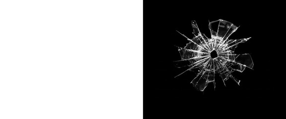 Fototapeta premium Shattered glass bullet hole on black background, realistic broken glass texture with radial cracks, damaged window pane overlay for composite design