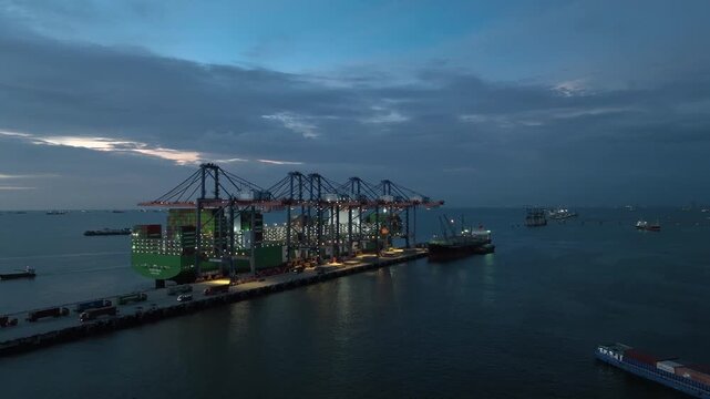 Aerial view container cargo ship loading unloading at night, Container cargo ship import export sea port, Global trade business container cargo ship freight shipping commercial trade logistic