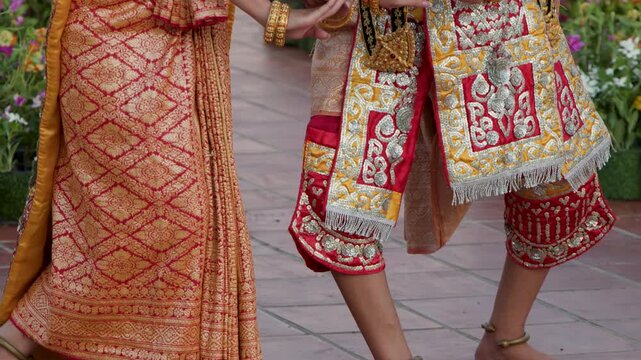 Thai Classical Dancers Performing in Traditional Golden Costumes