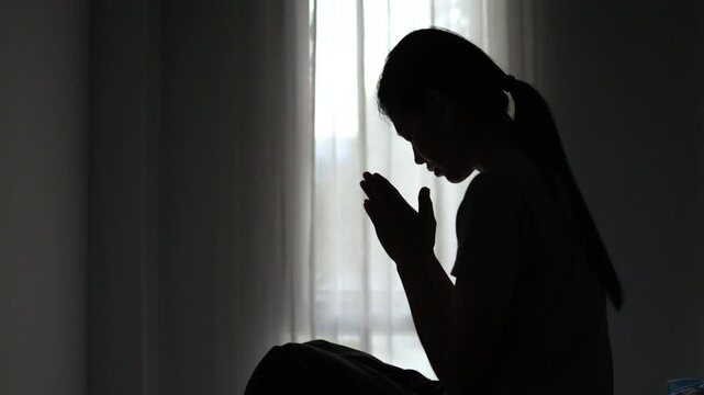  Silhouette of Christian Believer Praying Alone to God