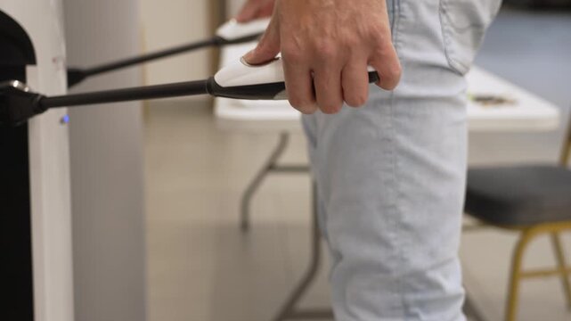 Close up view of a man undergoing a body composition test using a bioimpedance analysis machine