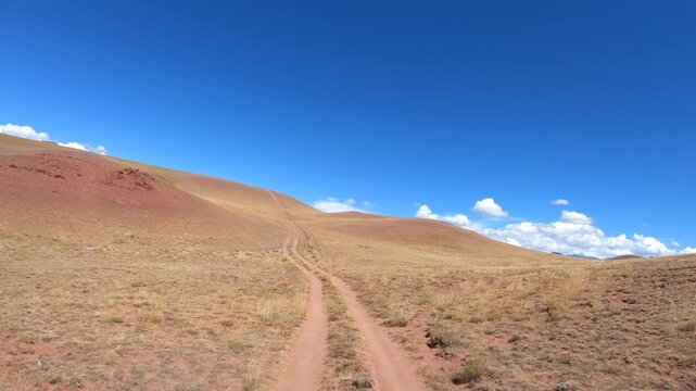 Driving along a country road in Altai desert and semi-desert environment.