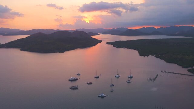 Aerial sunset view of boats anchored between islands in Coron Bay, Palawan.