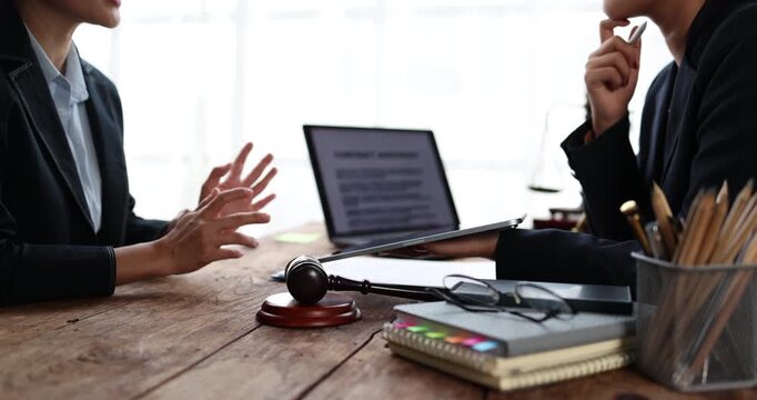 Legal professionals are engaging in a serious discussion, offering advice to a client in a modern office setting, symbolizing justice, law, and corporate consultation