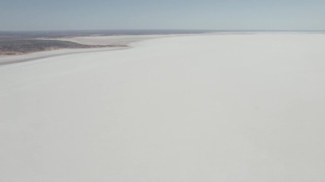 Cracked White Salt Crust Covering Surface of Dry Lake