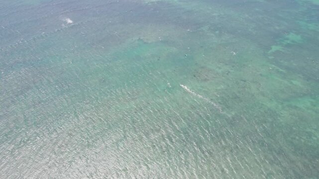 Kitesurfing Over Pristine Lagoon During Summer. Aerial Drone Shot