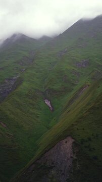 Lush green mountains disappear into the clouds