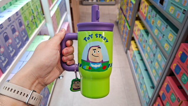 Person hand holding green Disney Pixar Toy Story Buzz Lightyear stainless steel insulated tumbler mug on September 17, 2026 in Bangkok, Thailand.