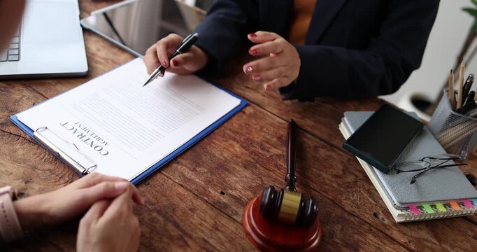 Legal professional consulting client in a modern office, offering expert advice and legal services, discussing important documents while providing professional support and justice