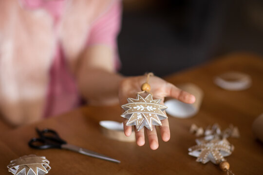 DIY gift handmade Christmas tree decorations: toy snowflakes made from toilet paper rolls. paper craft for kids. create art for children.